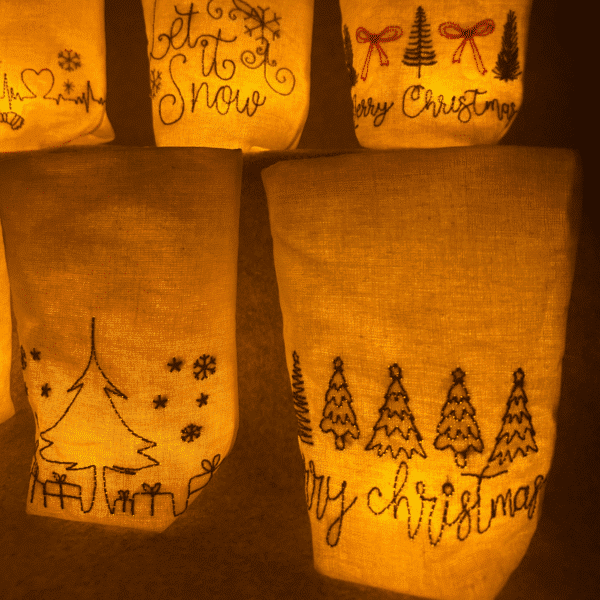 Lichtbeutel mit weihnachtlichen Motiven – Detailansicht von „Let it snow“, Geschenkbaum und Tannenwald