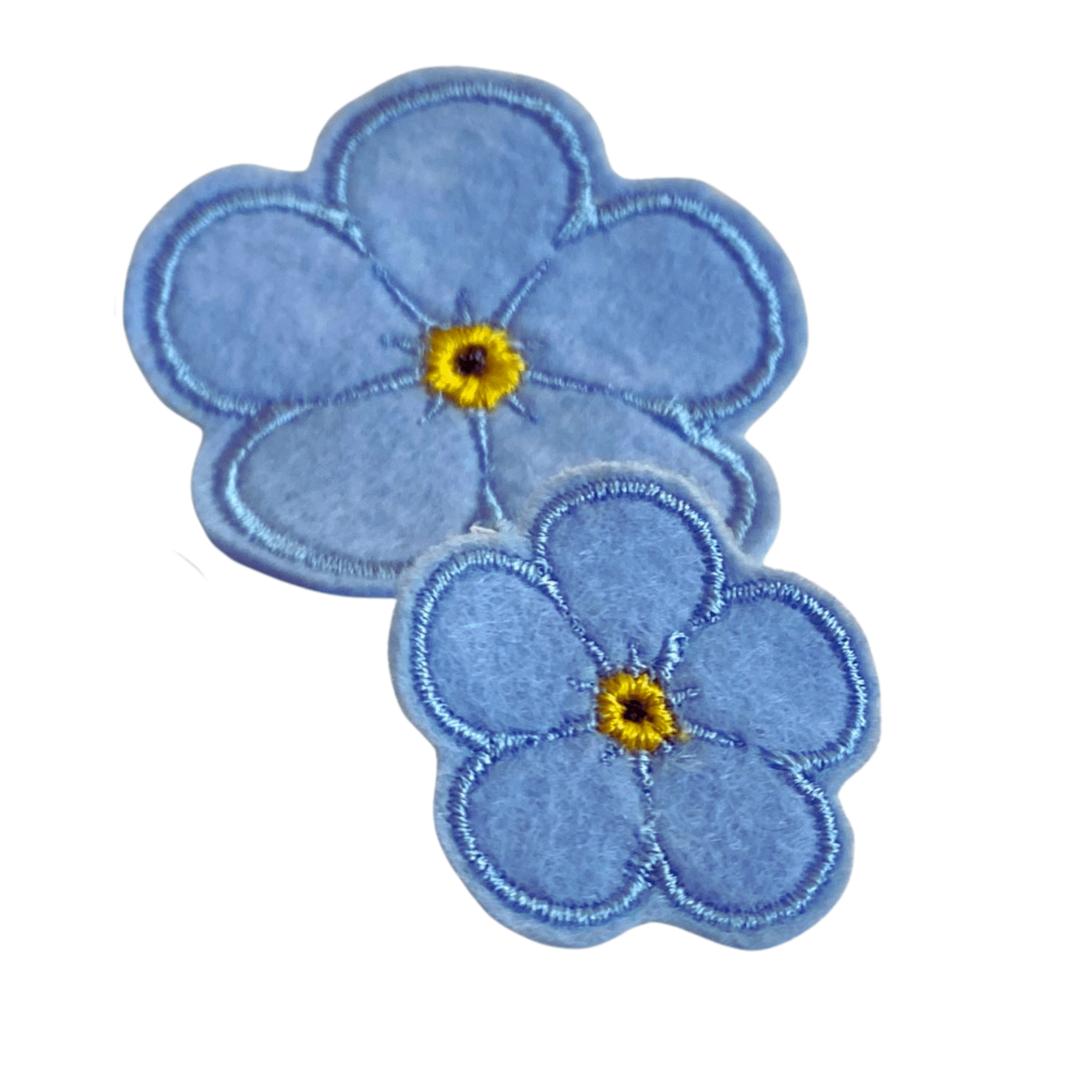 Zweier-Set des Forget Me Not Ansteckers in einfarbig hellblau, gestickt, in zwei Größen, auf weißem Hintergrund.