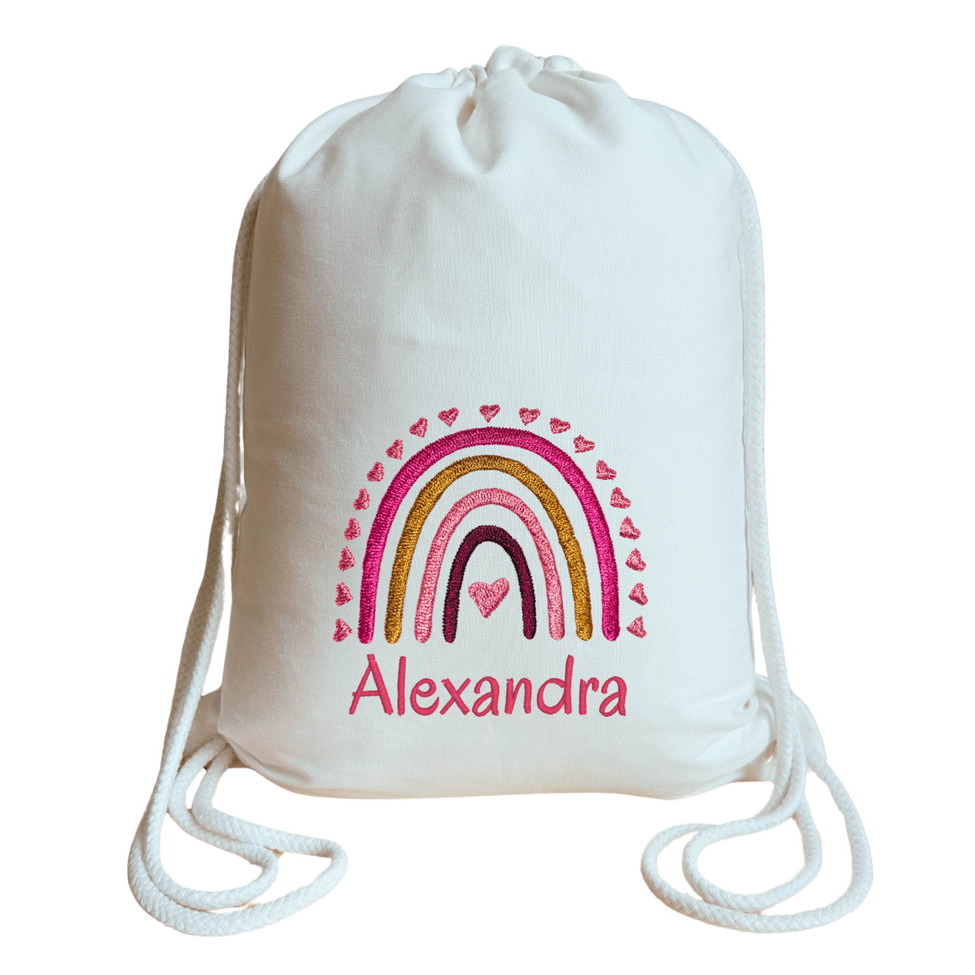 Personalisierter und bestickter Bio-Turnbeutel für Kinder mit niedlichem Regenbogenmotiv in Rosa- und Goldtönen, verziert mit kleinen Herzen und individuellem Wunschnamen, liebevoll und nachhaltig gefertigt.