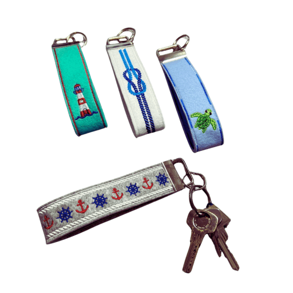 Schlüsselanhänger Maritim aus Filz mit maritimen Stickmotiven wie Leuchtturm, Knoten, Schildkröte, Steuerrad und Anker – Produktfoto mit Schlüsseln.