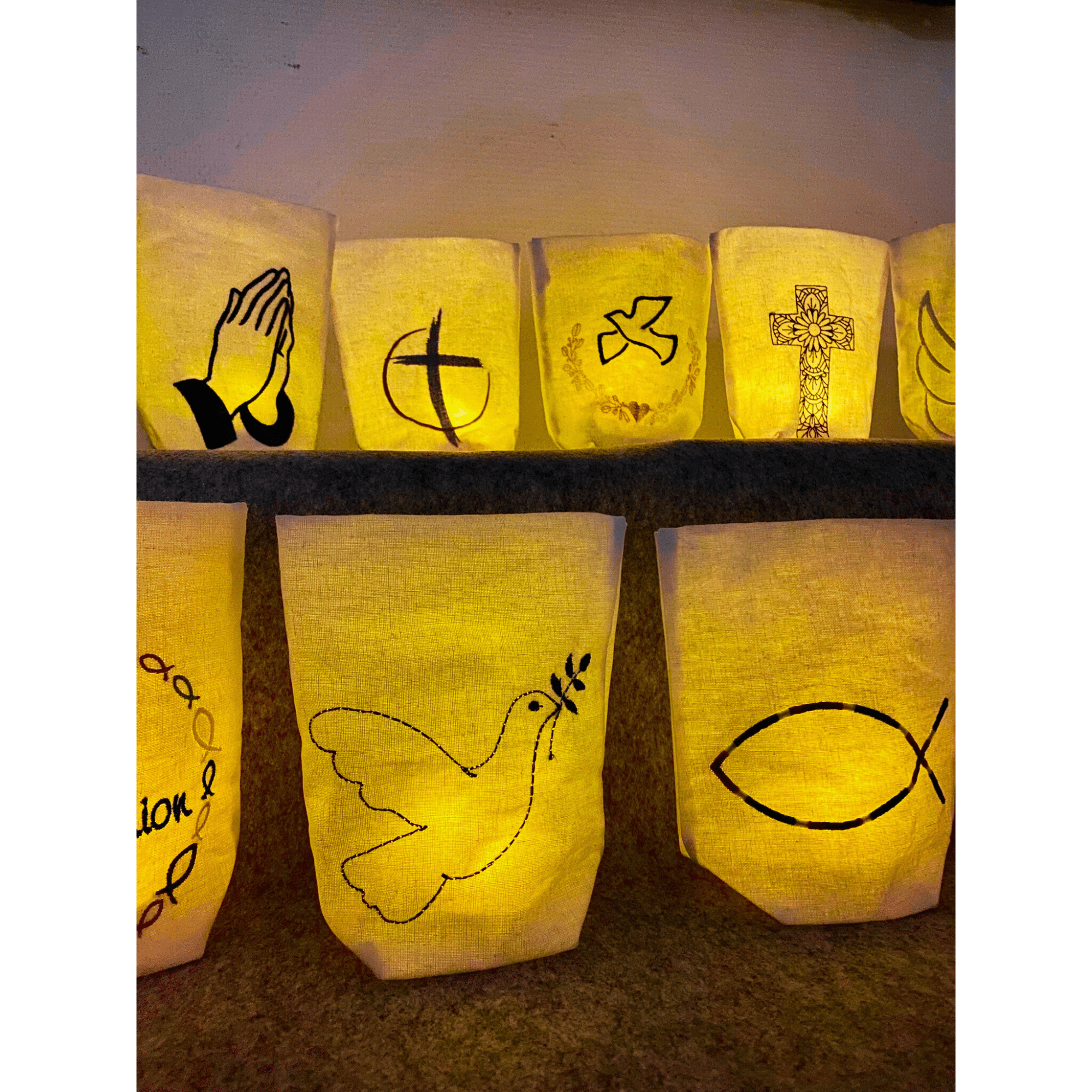 Lichtbeutel mit christlichen Motiven – Nahaufnahme mit Taube und Fisch