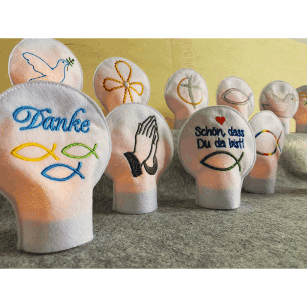 Teelichtcover mit christlichen Motiven aus Filz – bestickte LED-Deko im Tageslicht für kirchliche Feiern